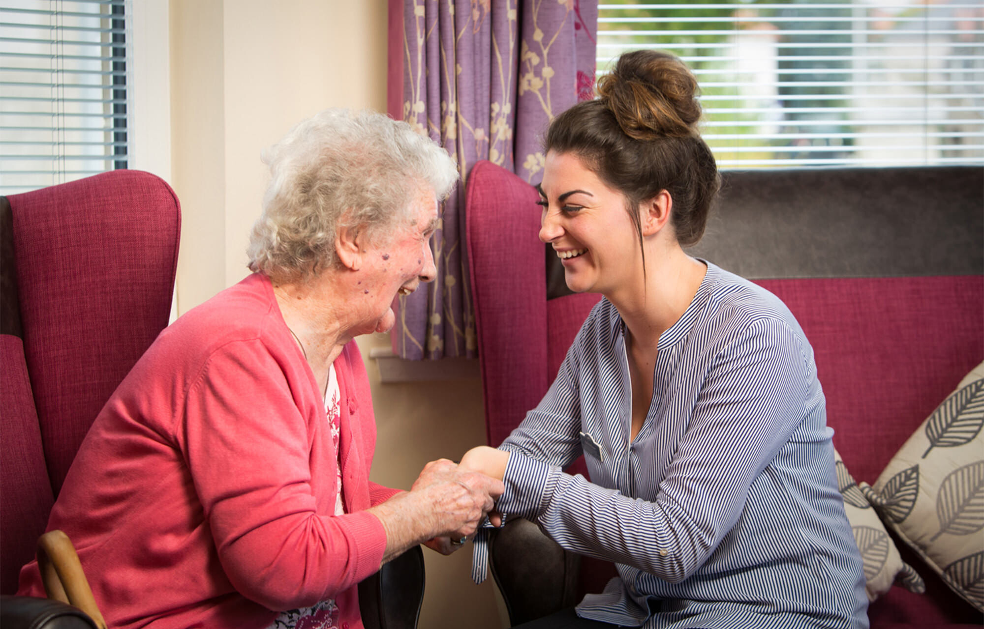 Elderly woman chatting with a healthcare worker